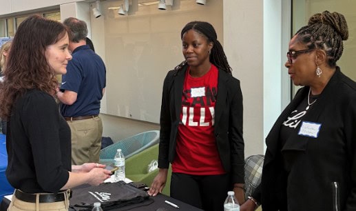 Eli Lilly sponsors of the Undergraduate Research Symposium talking with students.